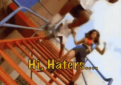a man and a woman are standing on a set of stairs with the words hi haters written in yellow