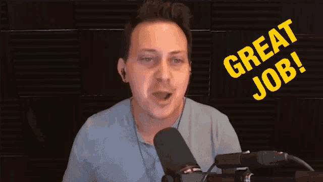 a man speaking into a microphone with the words great job above him