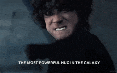 a man is making a face with the words `` the most powerful hug in the galaxy '' .