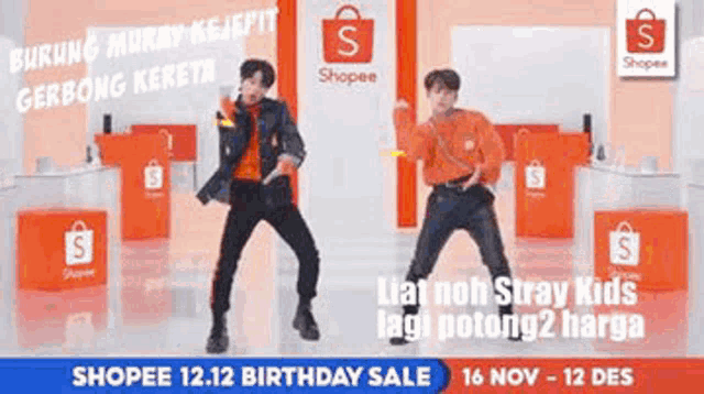 two young men are dancing in front of a shopee sign .