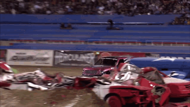 a demolition derby is going on in a stadium with a sign that says mercury