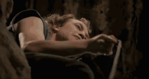 a man is laying on the ground with the words put the fucking lotion in the basket