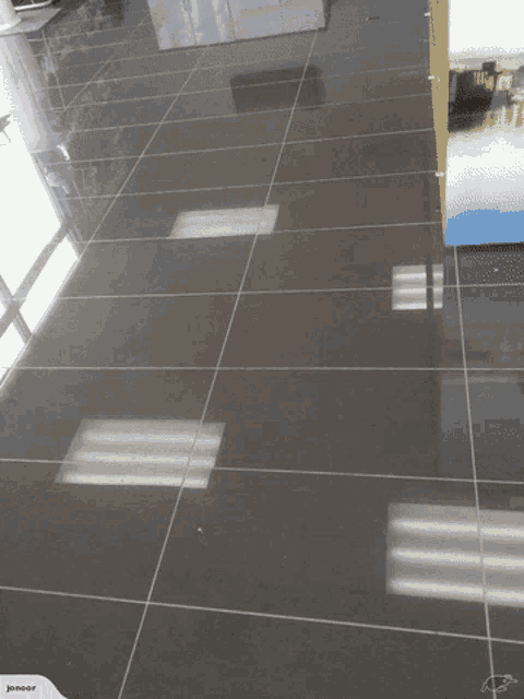 a kitchen with white cabinets and gray tile floor