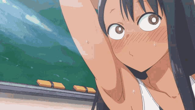 a girl in a white tank top is sweating her armpits in front of a green board