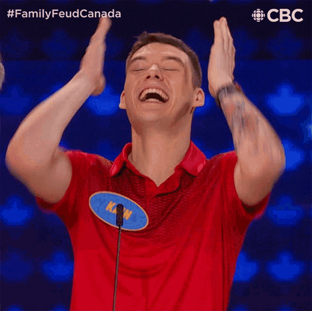 a man in a red shirt with a blue name tag that says kevin