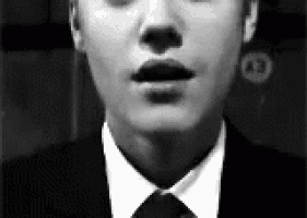 a man in a suit and tie is making a face in a black and white photo