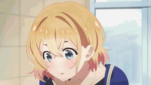 a girl with blonde hair and blue eyes is wearing a blue shirt
