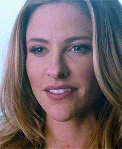 a close up of a woman 's face with her mouth open