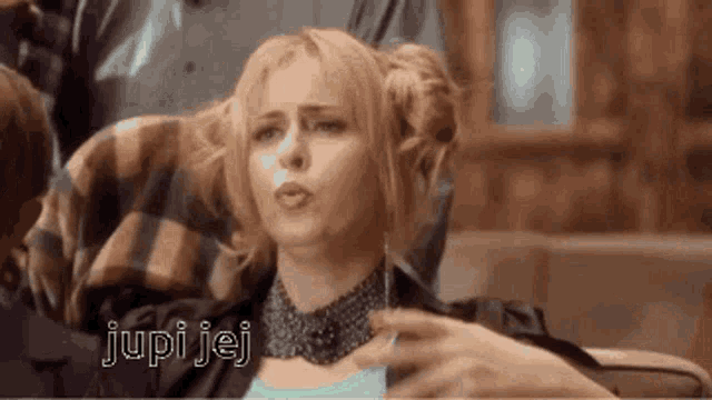 a woman is sitting on a couch with the words jupi jej written on the bottom
