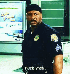 a police officer says " fuck y'all " in front of a poster