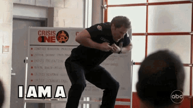 a man is jumping in front of a sign that says " crisis one "