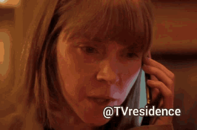 a close up of a woman talking on a cell phone with the words @tvresidence above her