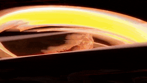 a close up of a flame coming out of a light bulb in the dark .