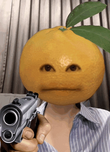 a person holding a gun with a lemon on their head