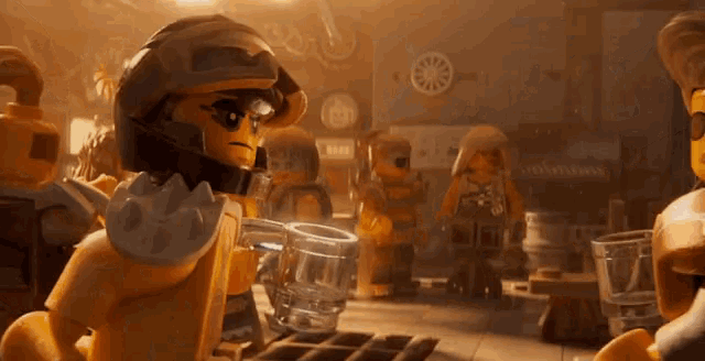 a group of lego figures are standing around a table with glasses of water .