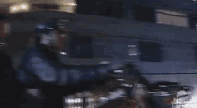 a man in a helmet is riding a motorcycle in the dark .