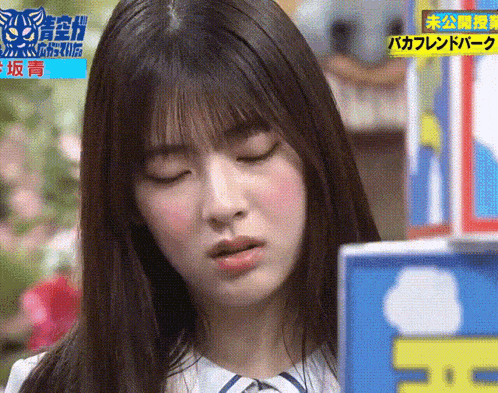 a close up of a woman 's face with chinese writing on the bottom right corner