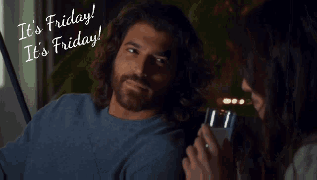 a man with long hair and a beard is sitting next to a woman and the words it 's friday