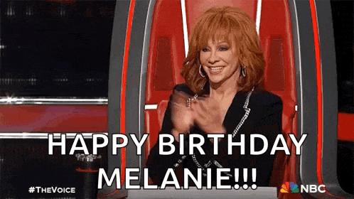 a woman is sitting in a chair applauding and saying `` happy birthday melanie ! ''