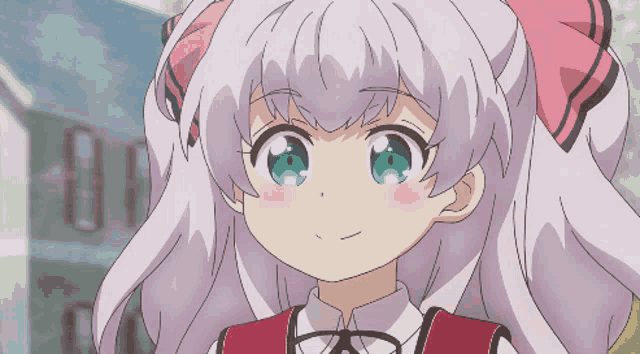 a girl with a pink bow on her head is smiling