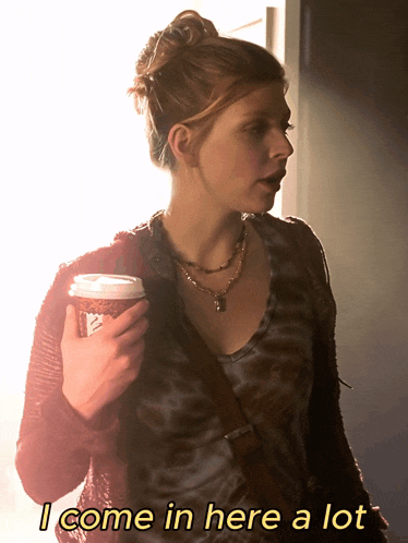 a woman holding a cup of coffee with the words " i come in here a lot " below her