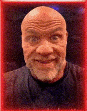 a man with a beard and a bald head is smiling