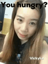 a woman is taking a selfie with the words `` you hungry ? '' written above her .