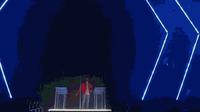 a man in a white cape stands in front of a giant statue
