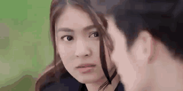 a man and a woman are looking at each other and making funny faces .