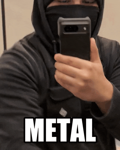 a man taking a picture of himself with the word metal written on the bottom