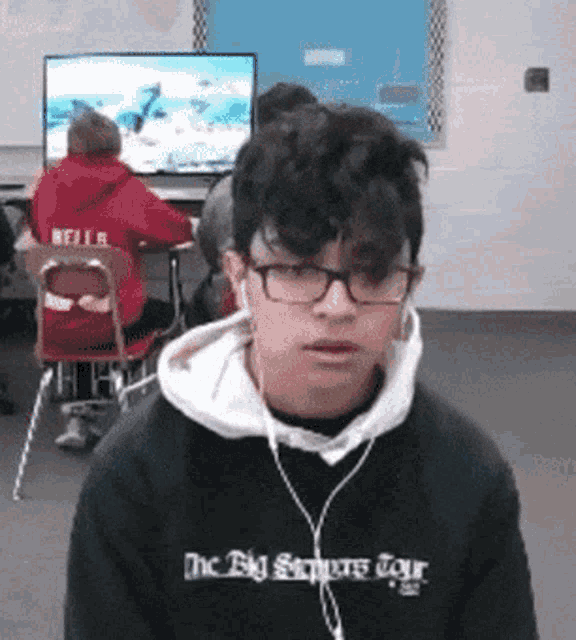 a boy wearing a black sweatshirt that says the big stoppers tour on it