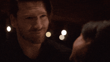 a man and woman are looking into each other 's eyes