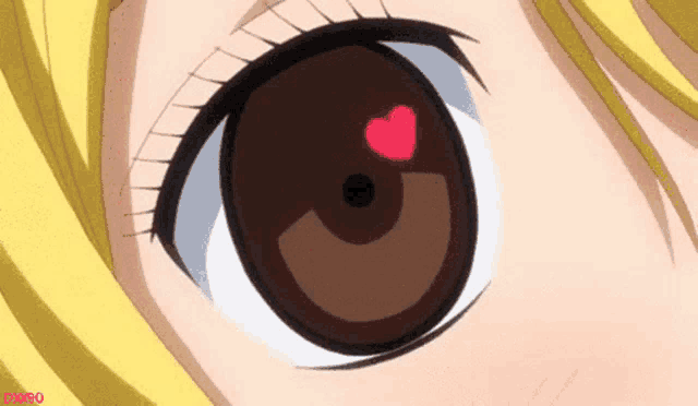 a close up of a girl 's eye with a red heart in it .