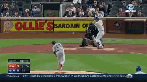 a baseball game is being played in front of an ollie 's bargain store sign
