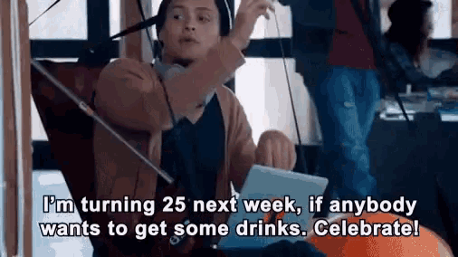 a woman is sitting in a chair with a laptop and headphones on and says i 'm turning 25 next week