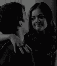a black and white photo of a man kissing a woman on the forehead .