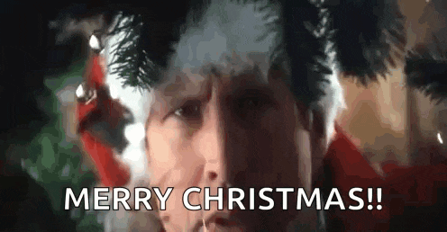 a man is wearing a santa hat and smoking a cigarette and says merry christmas .