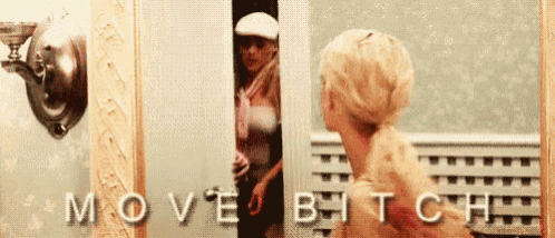 a woman is standing in front of a mirror with the words move bitch written on it