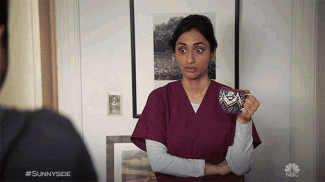 a woman in a purple scrub is holding a cup with the hashtag #sunnyside on the bottom right