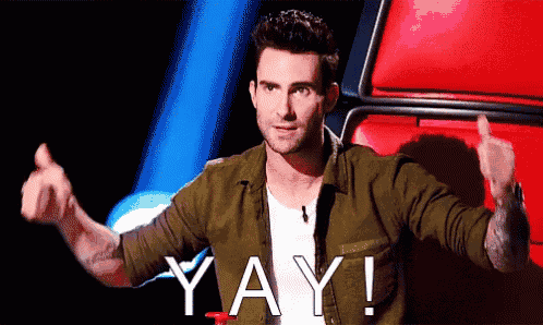 a man in a green shirt is giving a thumbs up and the word yay is on the screen