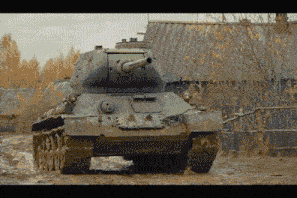 a tank is driving down a dirt road in front of a fence