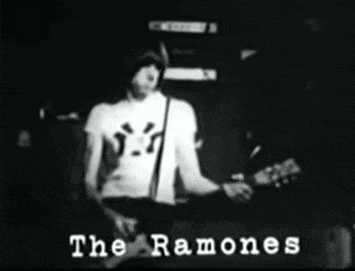 a black and white photo of a man playing a guitar with the words " the ramones " on the bottom right