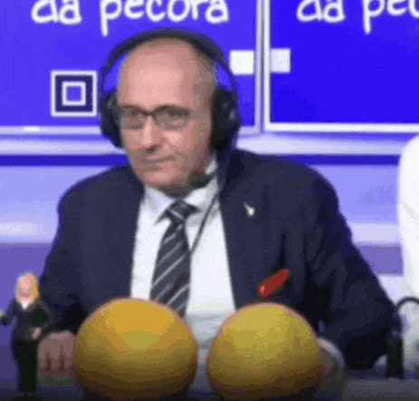 a man wearing headphones holds two yellow balls