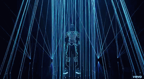 a person is standing in a room with a lot of blue lights .