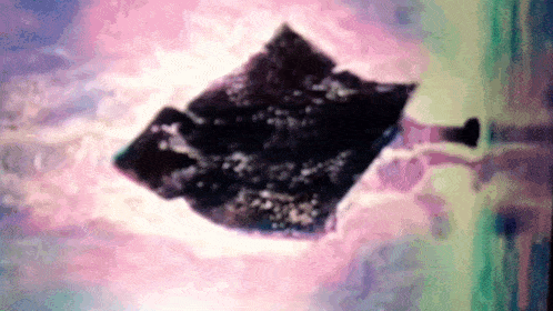 a person is laying on a bed with a blanket on it .