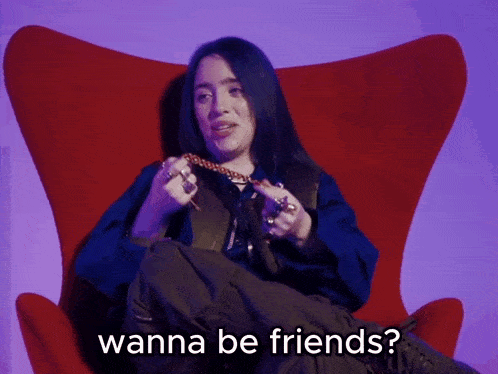 a woman sitting in a red chair with the words wanna be friends