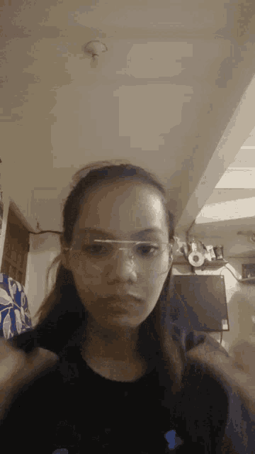 a girl wearing glasses looks at the camera