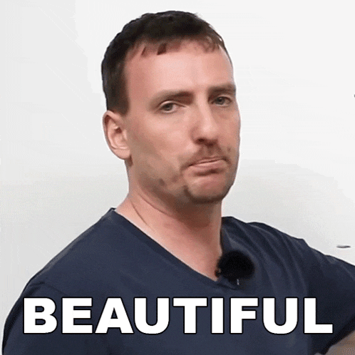 a man wearing a blue shirt with the word beautiful on the front