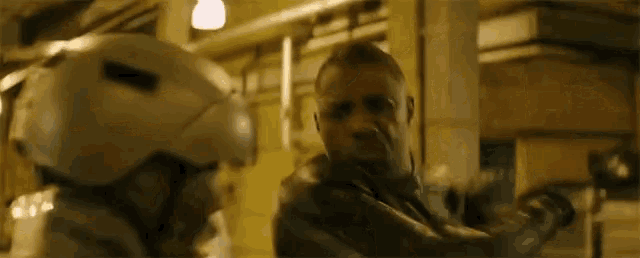 a man wearing a helmet is fighting another man in a street .