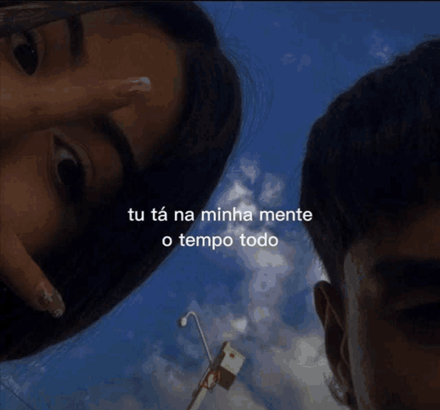 a man and a woman are looking at the camera with the words tu ta na minha mente o tempo todo above them